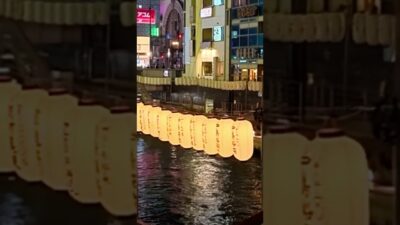 Walking across the Shin-Ebisu Bridge, where Osaka sightseeing cruise boats pass underneath.